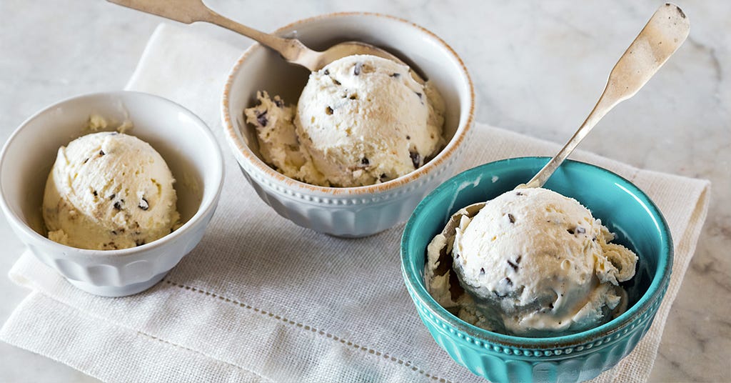 Three bowls of ice cream on a table cloth