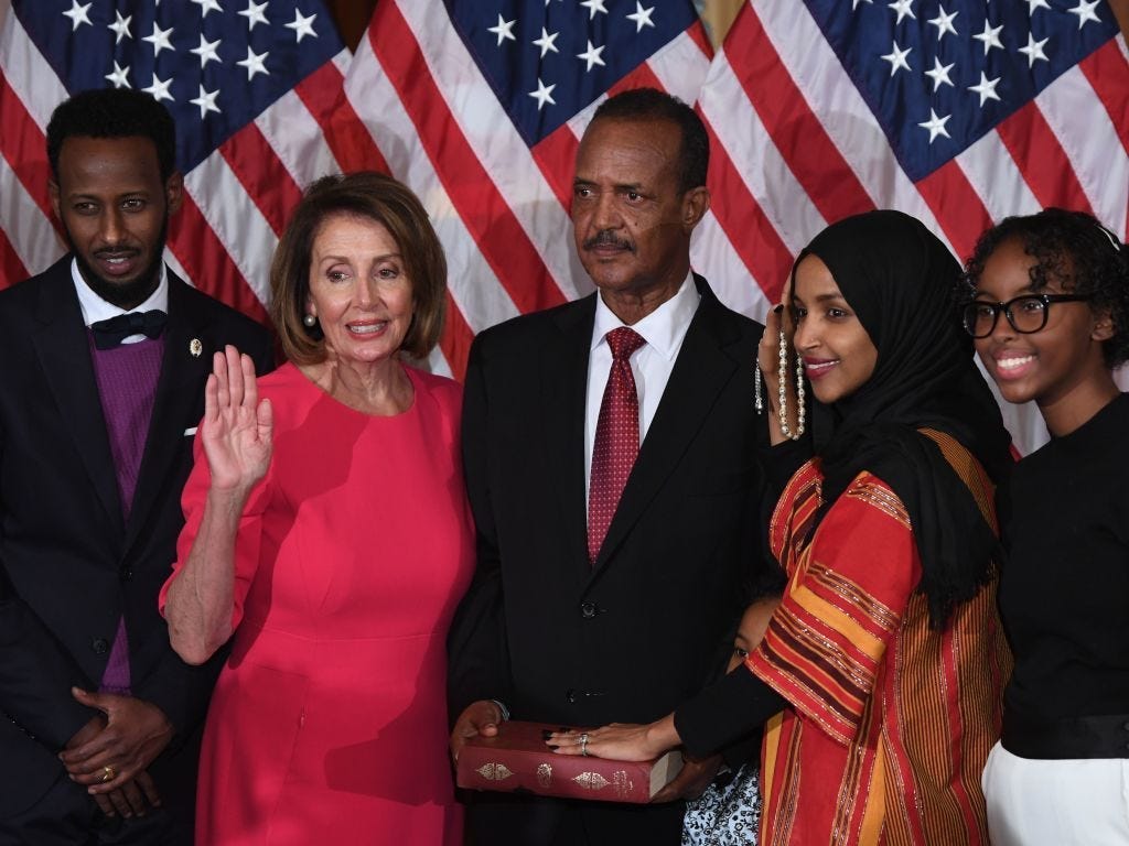 Speaker of the House Nancy Pelosi performs a ceremonial swearing-in for Rep. Ilhan Omar.