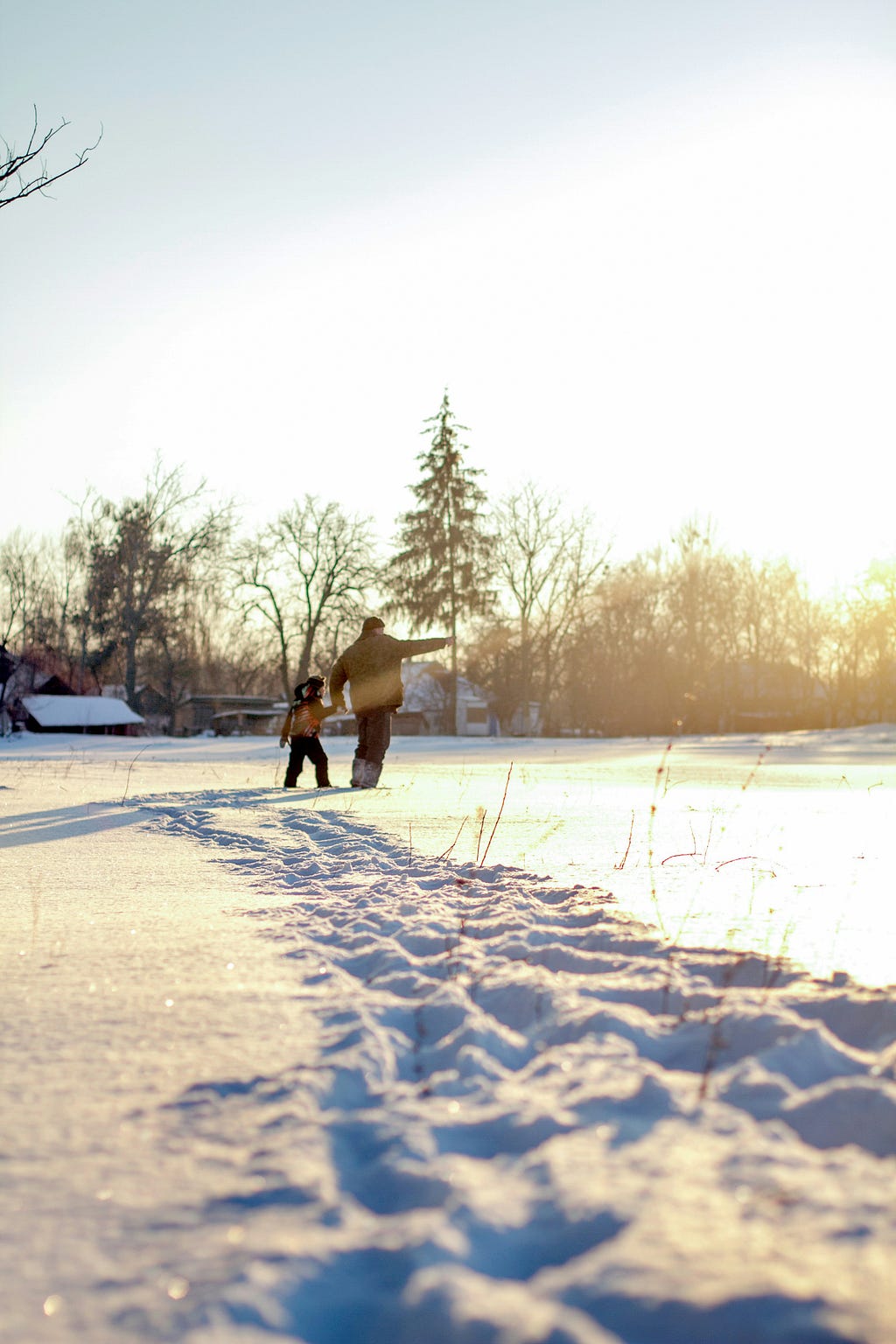 Boy and grandfather enjoying the sunny snowy day