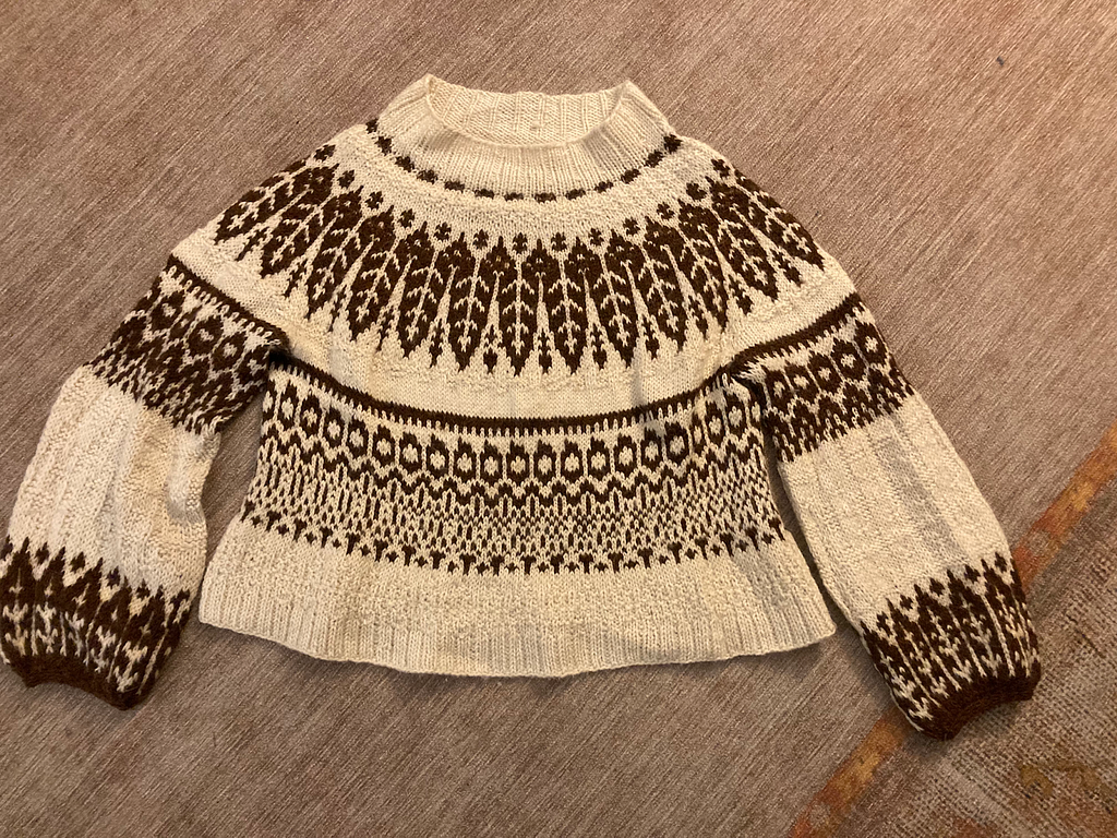 A photograph and a brown-and-cream hand-knit wool sweater