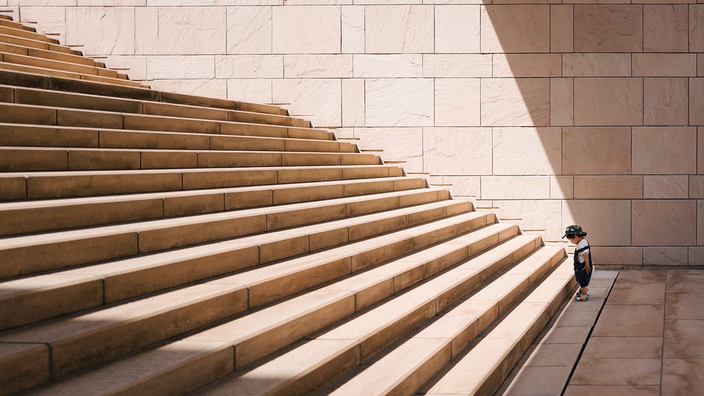 Image shows a person at the bottom of a huge set of steps