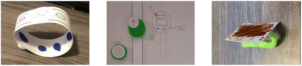 1. Vibrating Ring: A sleek white ring with vibrant blue and purple accents with a vibration feature for notifications or alerts. 2. Tamagotchi-like Watch: A playful watch design featuring a screen with a green Tamagotchi-style digital pet. 3. Vibrating Hairclip: A unique hairclip with a green base and brown top.