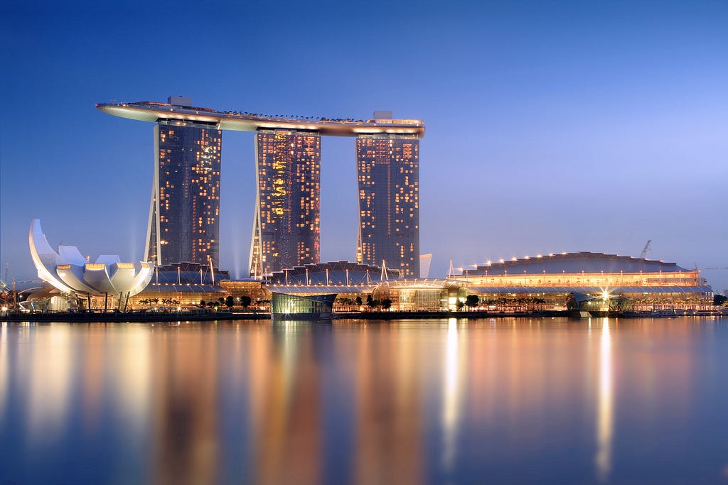 The Marina Bay Sands Towers In The Evening. Image by https://en.wikipedia.org/wiki/Marina_Bay_Sands#/media/File:Marina_Bay_Sands_in_the_evening_-_20101120.jpg.