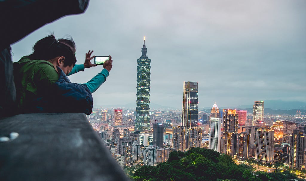 Someone takes a picture of a city at dusk