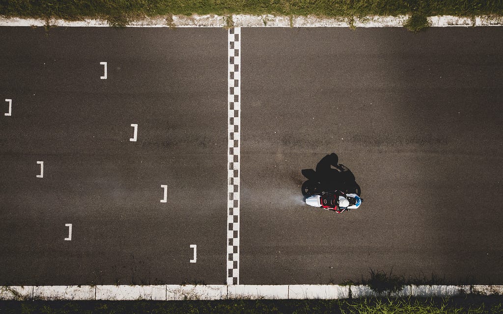 bird’s eye view of person driving a motorcycle