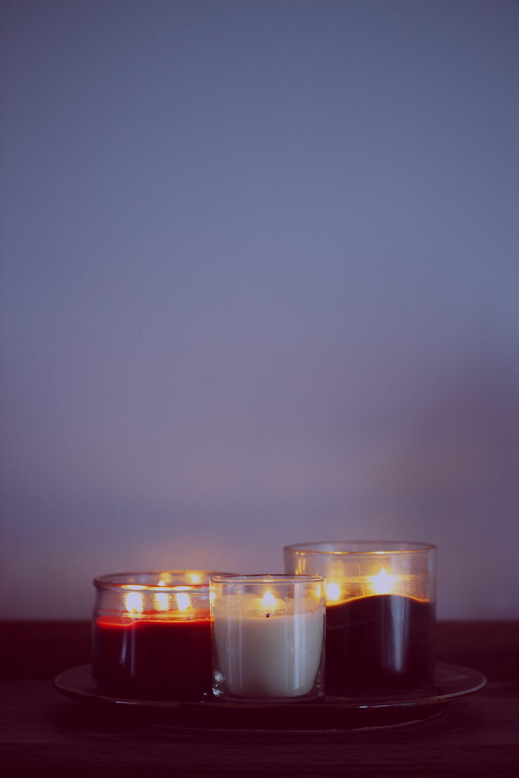 Three lit candles on a peaceful background