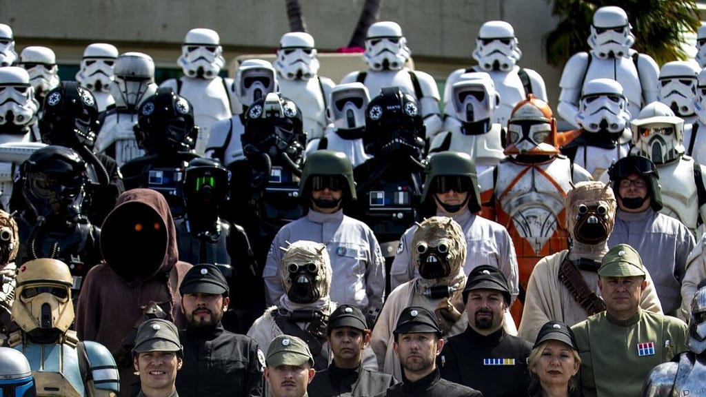 But in this alternate UIverse, human beings embrace the headgear. We may gawk at someone wearing a Daft Punk helmet, but there are also Stormtroopers, Mandolorians, and Darth Vaders in our natural environment, leading us to wonder how we can accept the various tribes among human society.(source: Los Angeles Times)