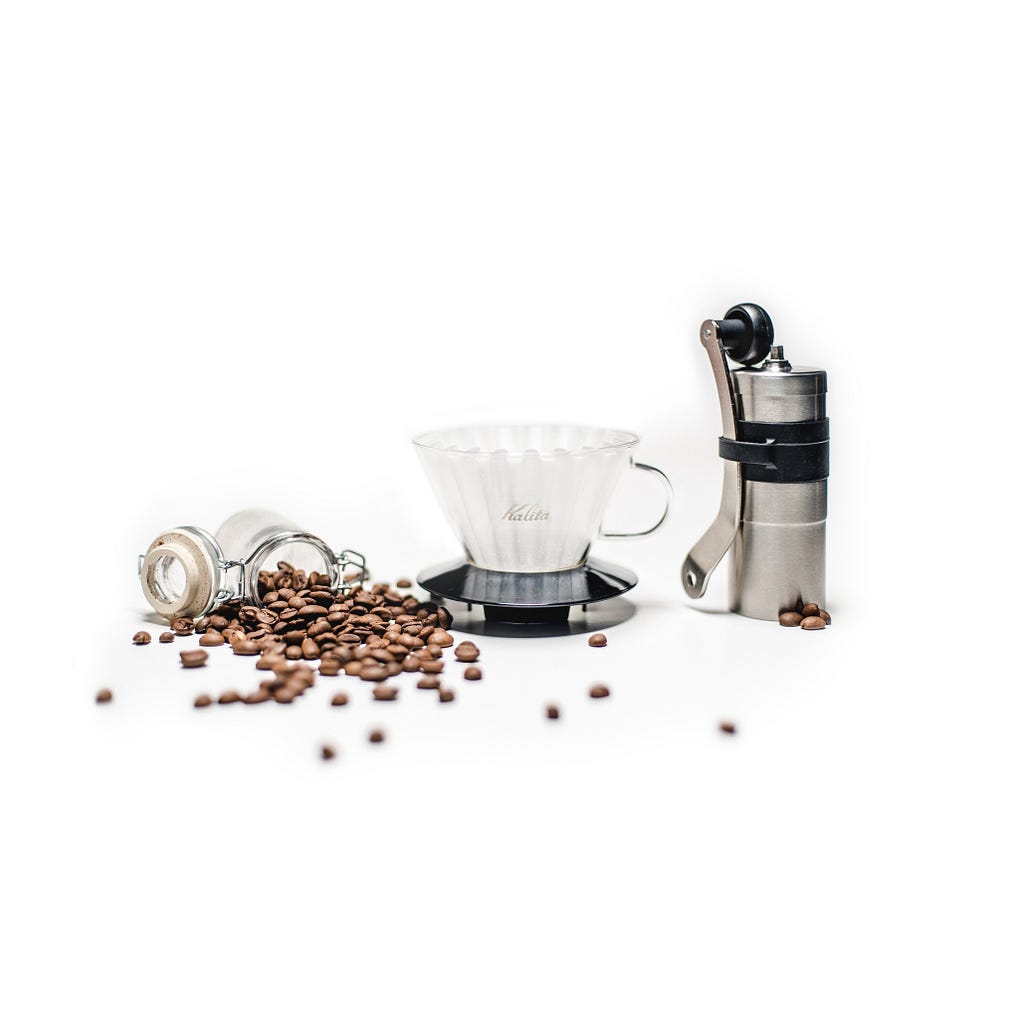 coffee beans and coffee grinder next to V60