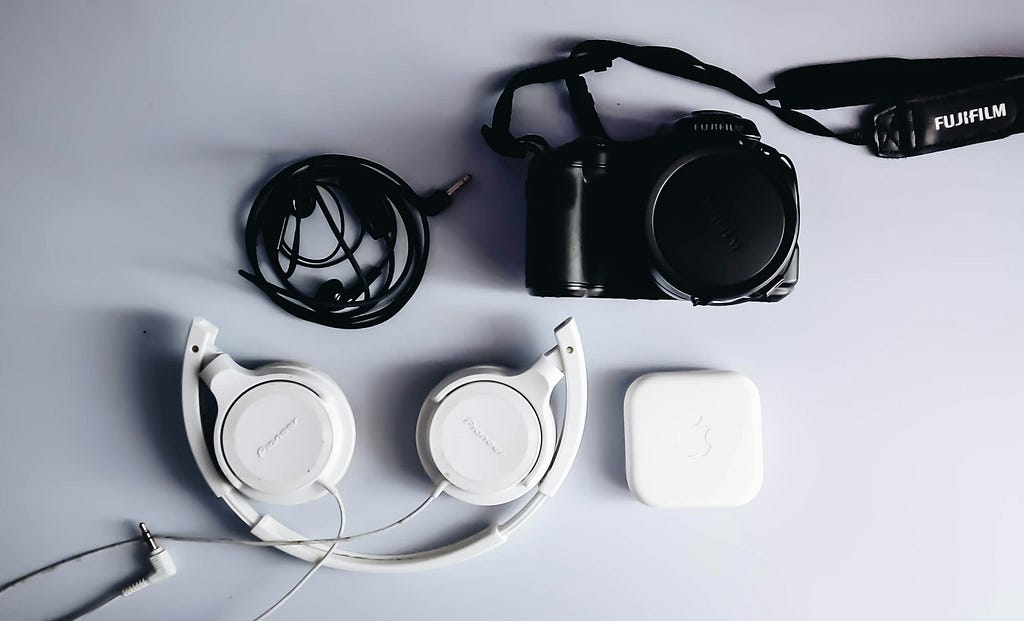 A camera, earphonnes, headphones and earbuds