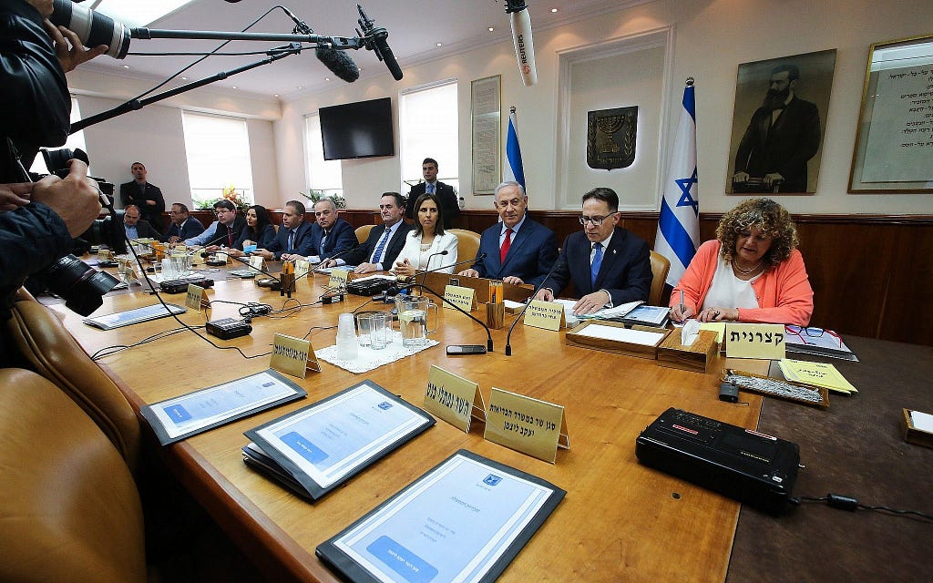 A picture of Benjamin Netanyahu and his cabinet of ministers sitting at a press conference back in 2019 discussing the expansion of the cabinet.