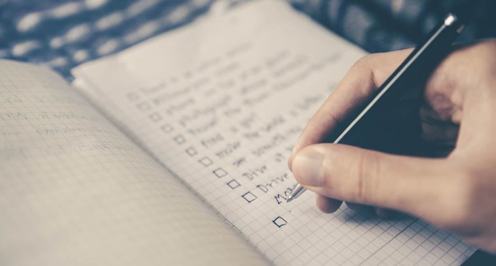 Man creating checklist for his business