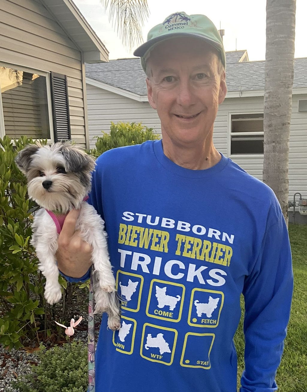 Man holding dog, wearing stubborn Biewer Terrier Tricks t-shirt