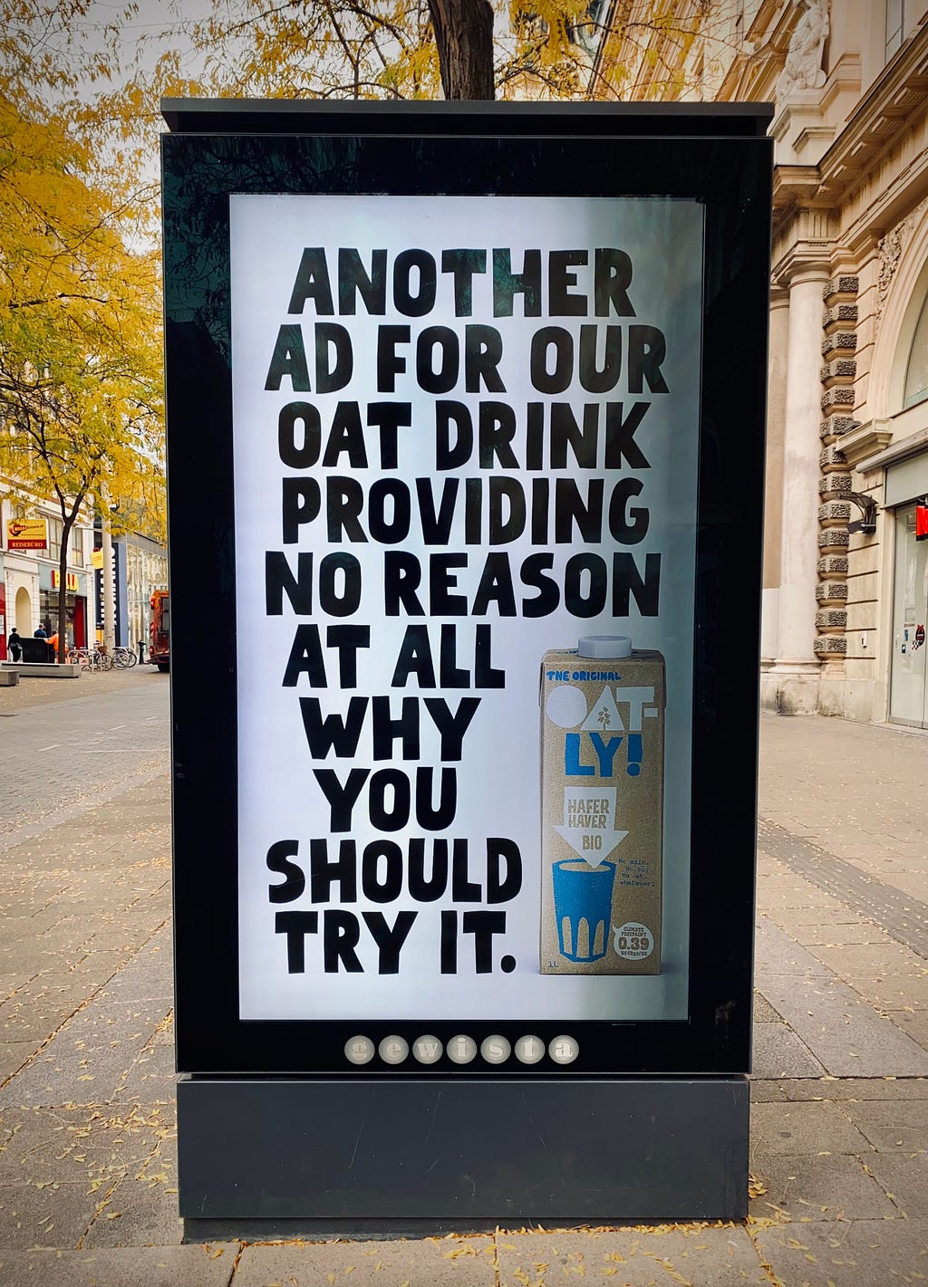 An advertisement from Oatly on a bus stop, saying “Another ad for our oat drink providing no reason at all why you should try it”