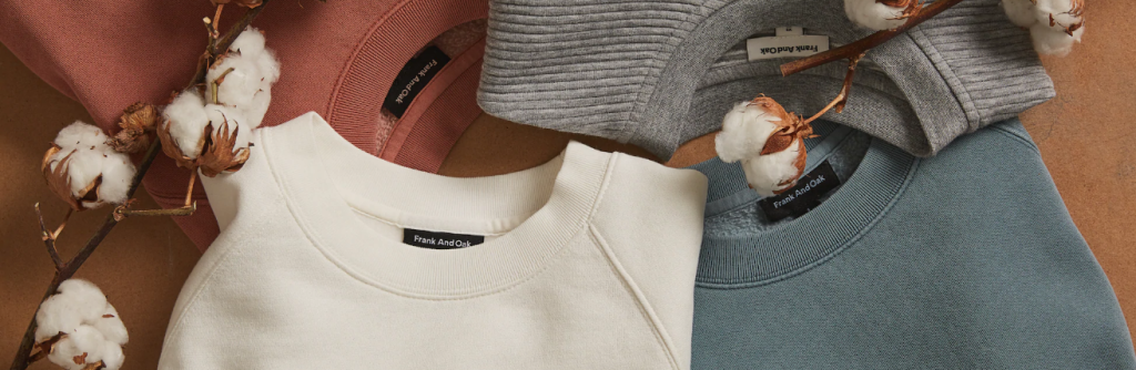 Crew neck sweaters of varying colors with raw cotton on the stem