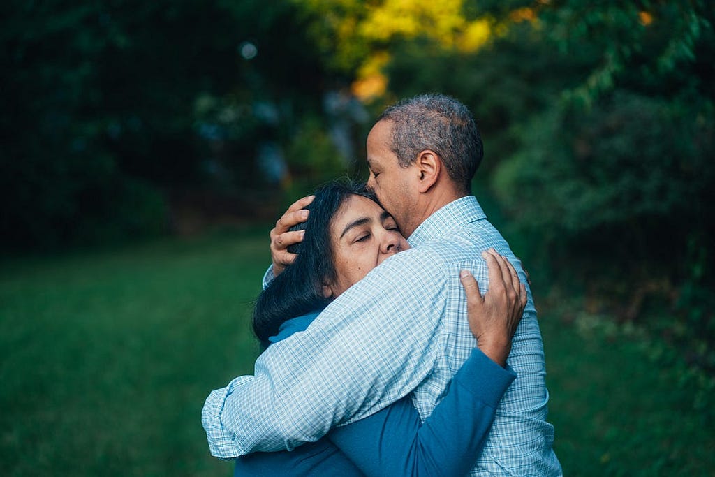 A woman and a man hugging each other