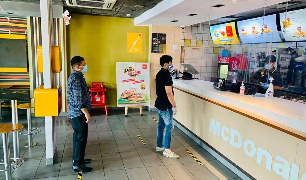 People waiting in a queue to order over the counter at McDonald’s