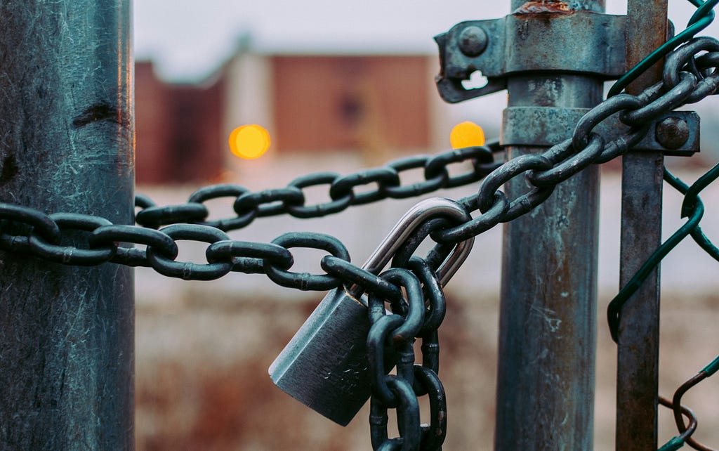 Lock and chain on metal fence