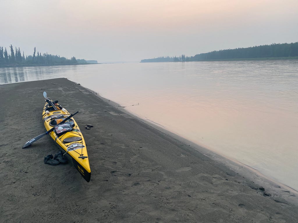 A kayak on a beach overlooking the Yukon river.