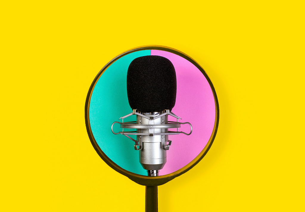 Photo. Against a yellow background, there is a picture of a microphone, that at the same time, is placed against an aqua green and pink background. Credit: Canva