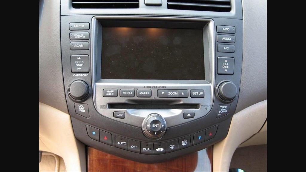 Old car dashboard with outdated infotainment system.