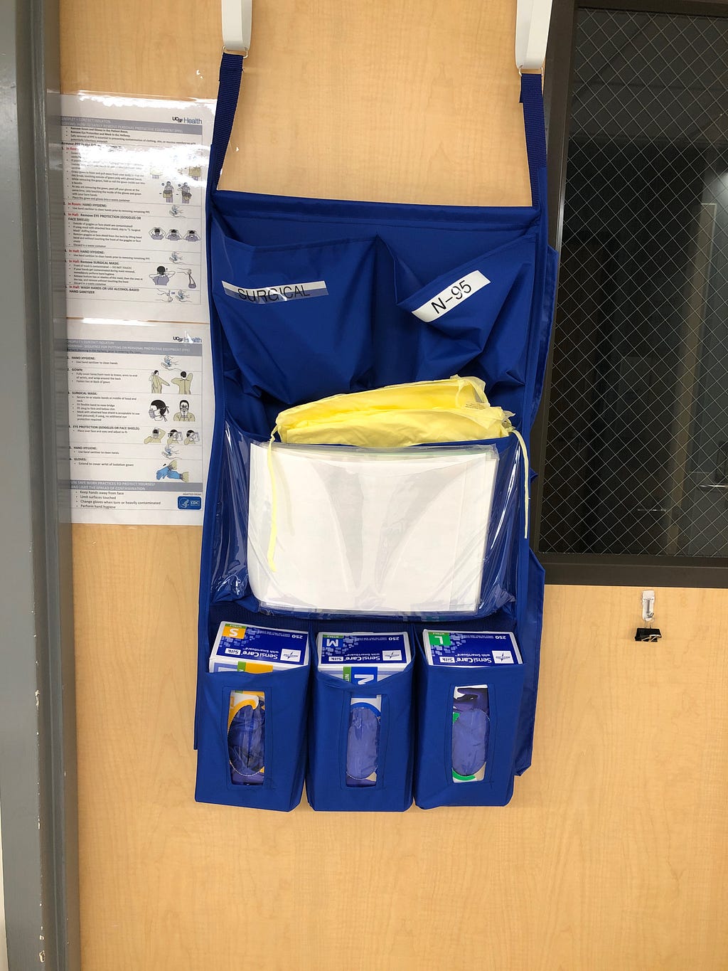 Personal protective equipment hanging outside of a patient’s room