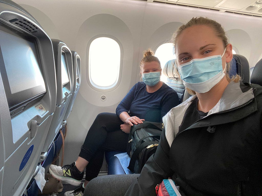 Lauren and her wife, seated on the airplane en route to Germany