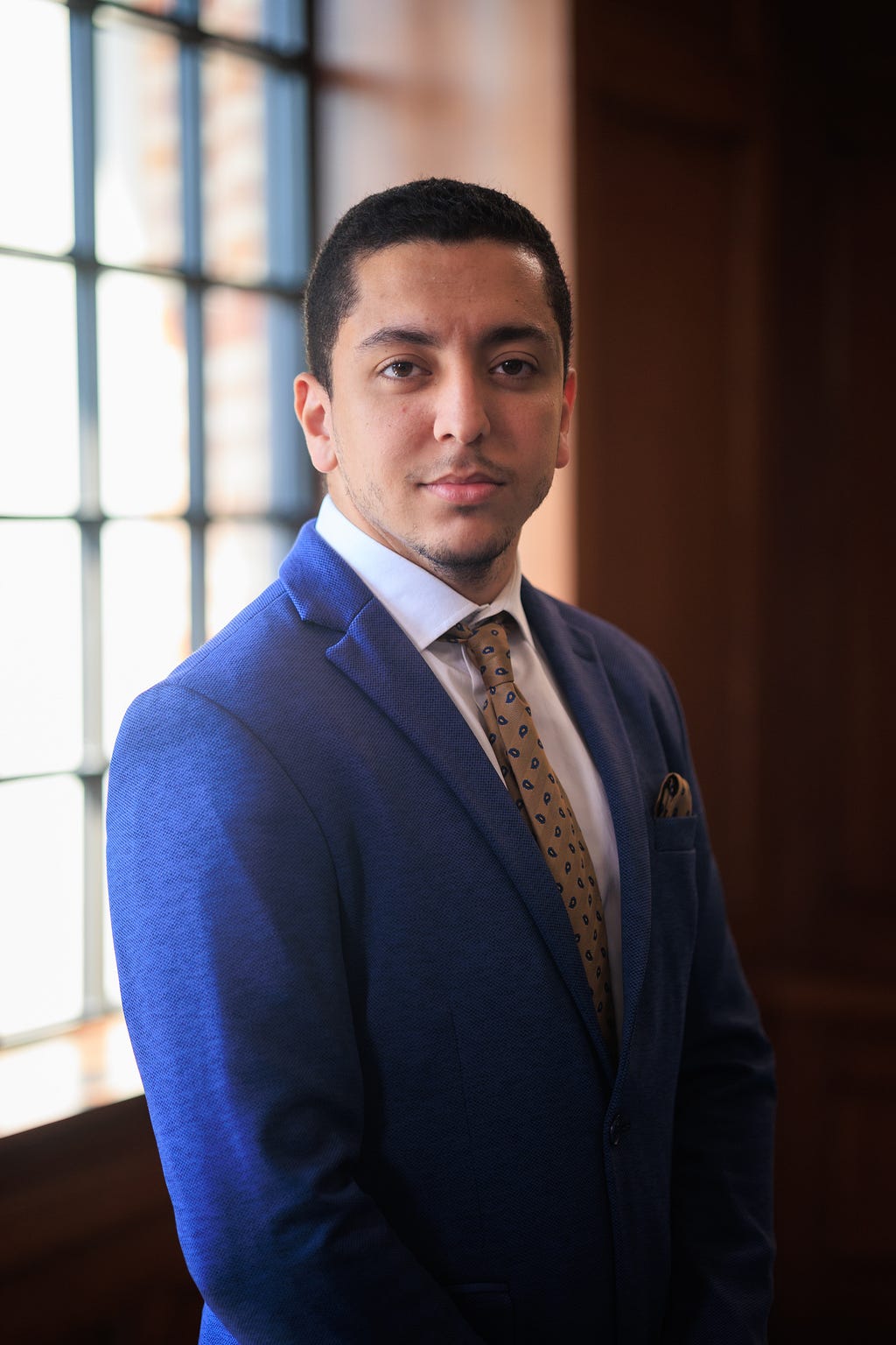 Professional headshot of the author wearing a suit and tie.