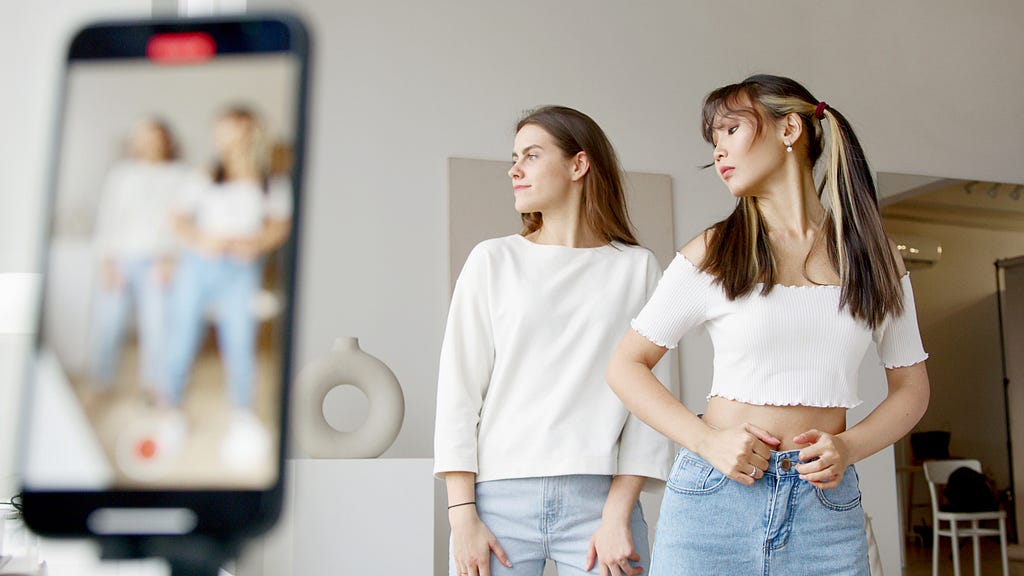 Two teens doing a TikTok dance challenge.