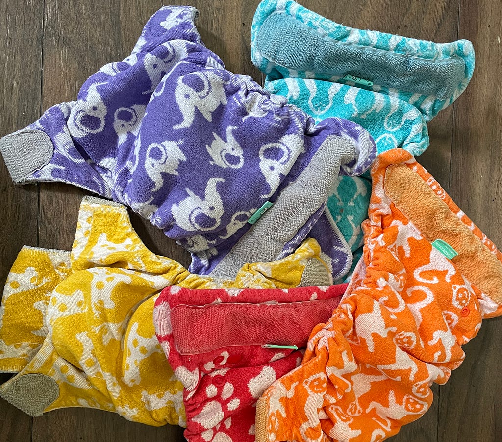 5 nappies in different colours with animal prints