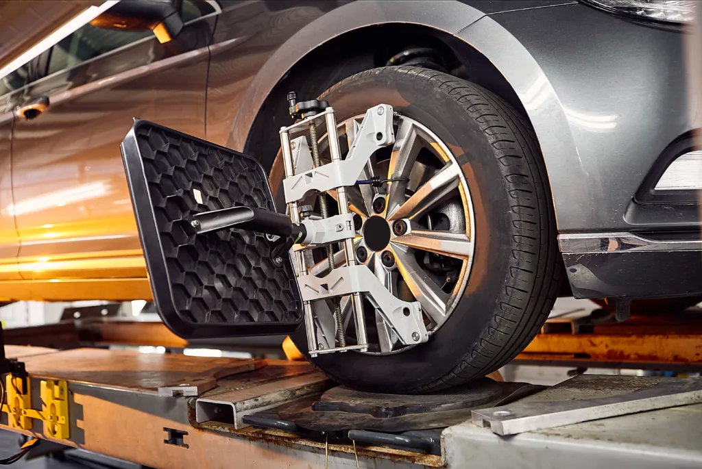 A car wheel attached to wheel alignment equipment.