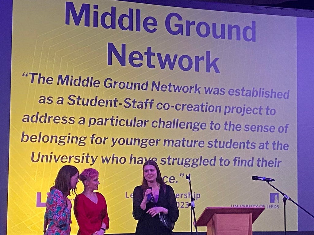 Laura Conroy (LLC Student Success Officer), Lauren Huxley (LLC Student Experience Officer) and Zofia Wilk (Middle Ground Network Engagement Coordinator) on stage accepting the Overall Partnership Award.