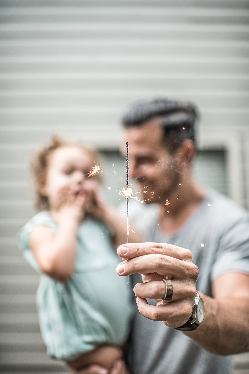 A father and daughter enjoying firecrackers