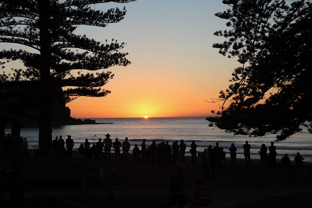 Sunset on beach with people in foreground
