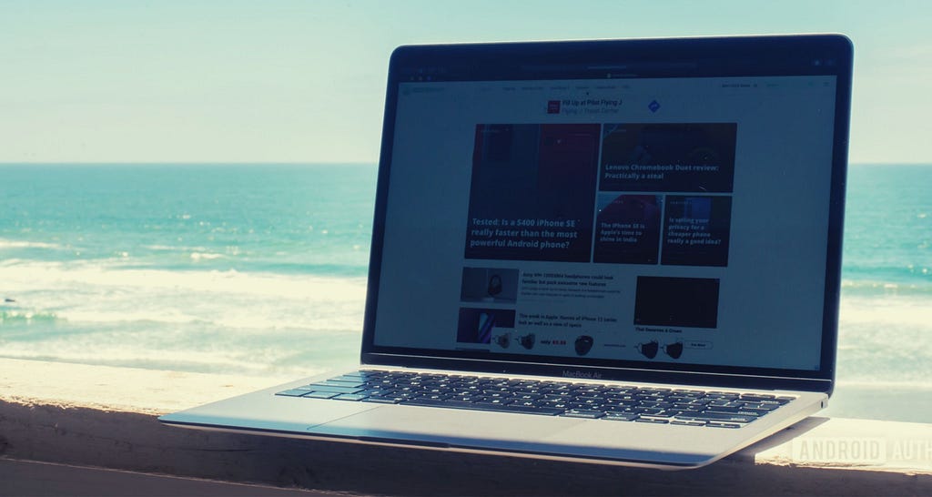 A laptop with a beach in the background.