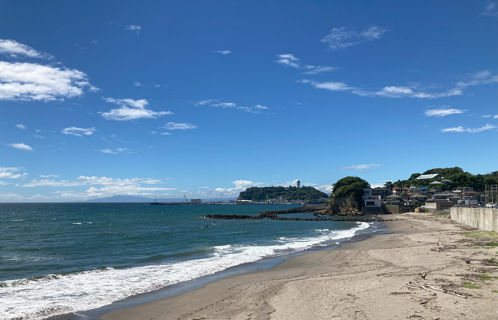 Photo of the beach with Enoshima in the background.