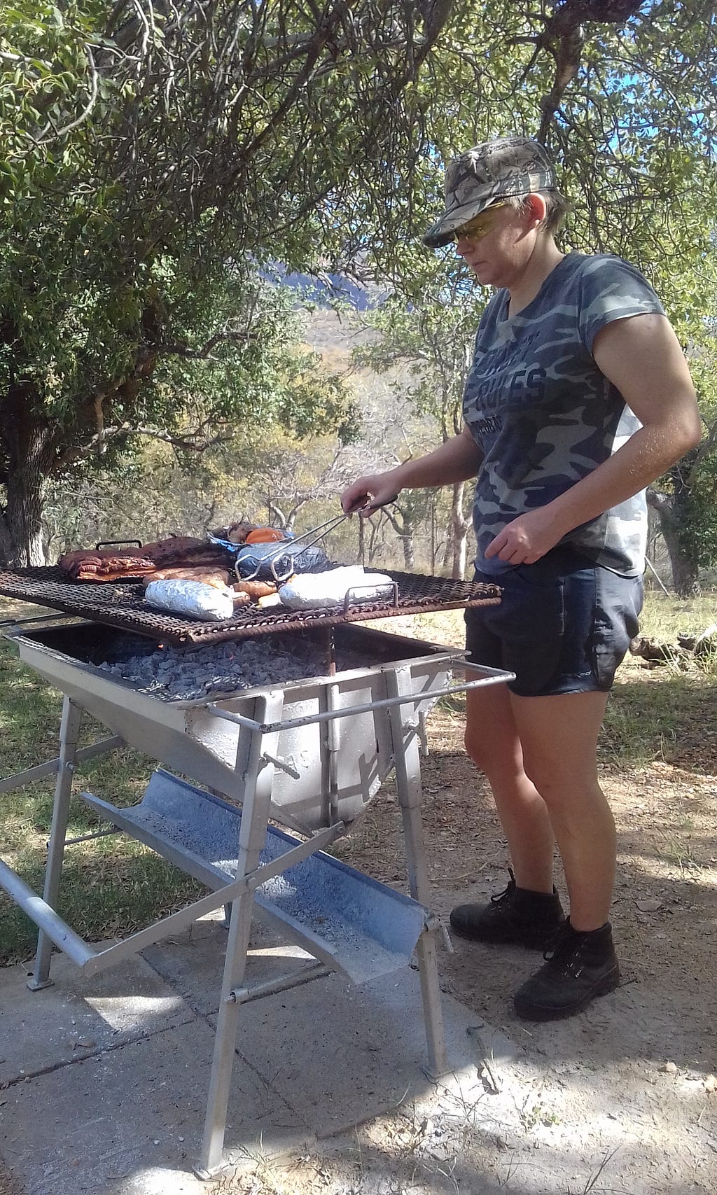 Author having a braai, with plenty of meat on the grill