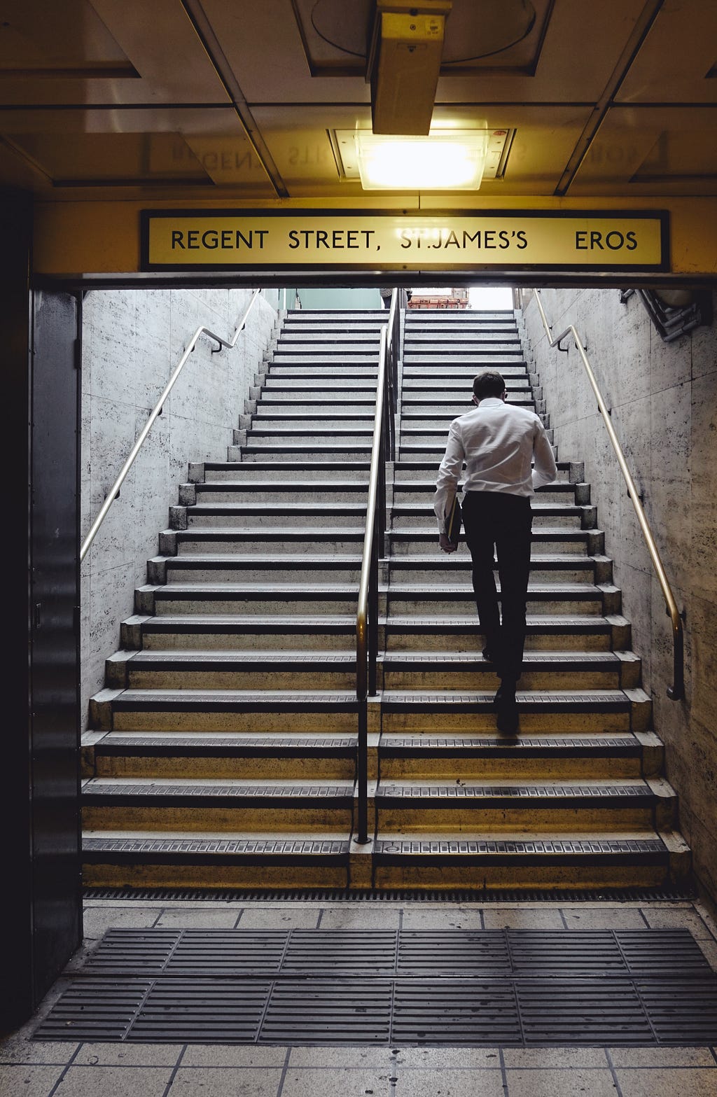 Man climbing subway’s stairs commuting to work