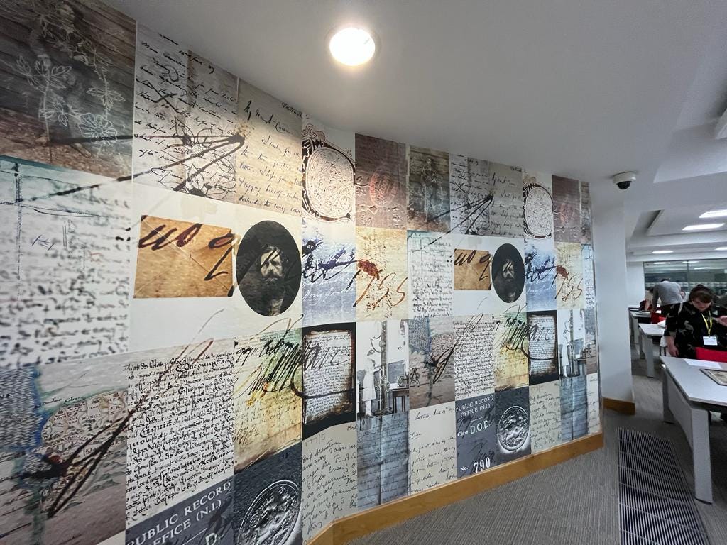 A view inside the Public Record Office of Northern Ireland showing floor to ceiling graphics covering a wall. Photograph taken by Natalie Adams.