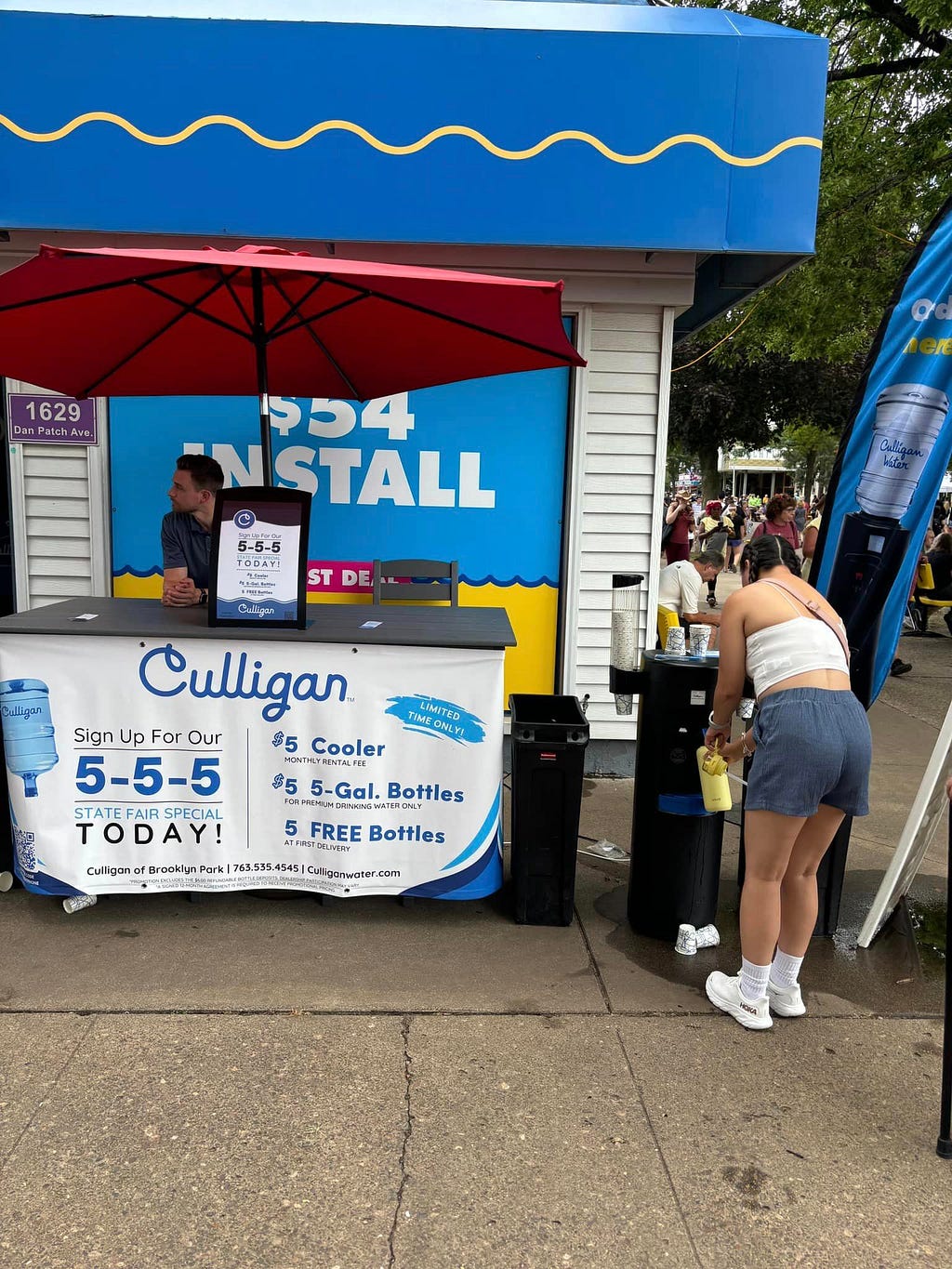 Fairgoer fills a water bottle at the Culligan stand at the Minnesota State Fair.