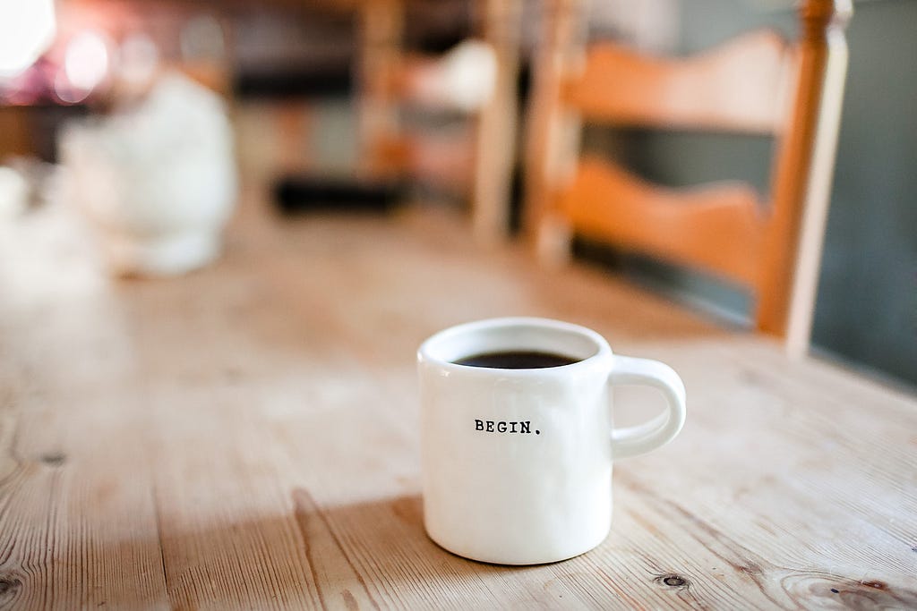 Coffee mug with the sentence “Begin.” on it