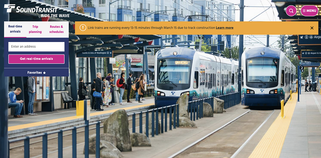 Sound Transit homepage. Image of two trains outside on the track with people waiting on the left. Search box in top left.