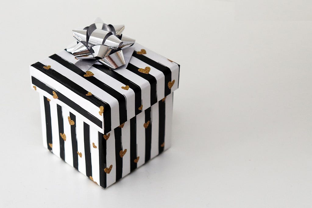 gift box with bow striped black with gold hearts