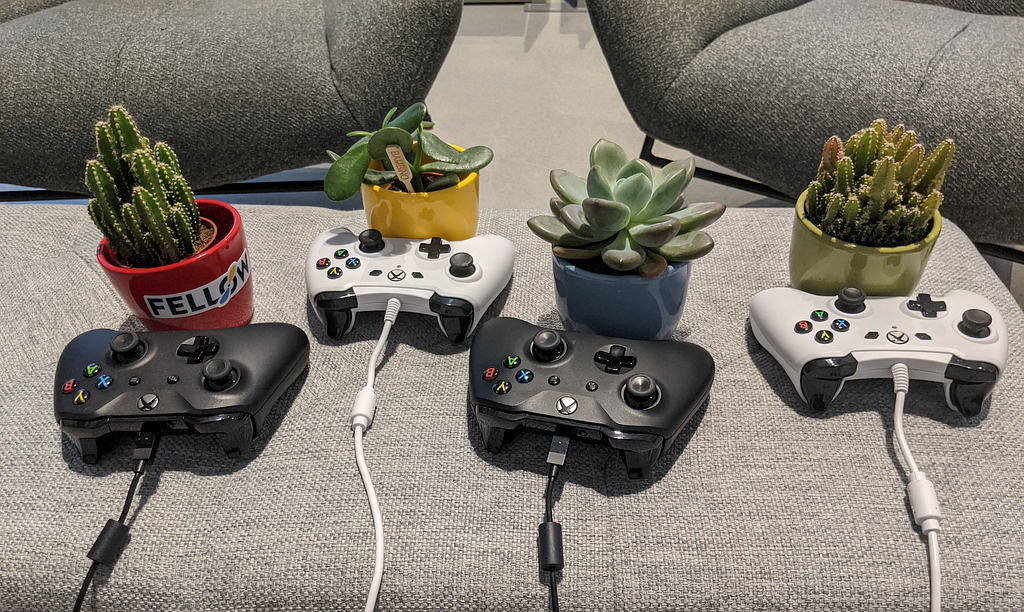 Four succulents with Xbox controllers, playing video games together