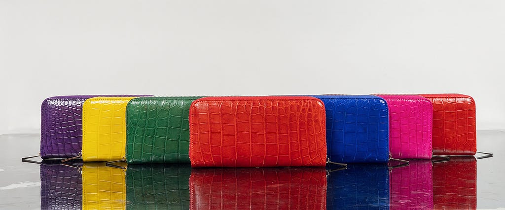 Group of genuine crocodile skin wallets for women with different colors from Sherrill Bros