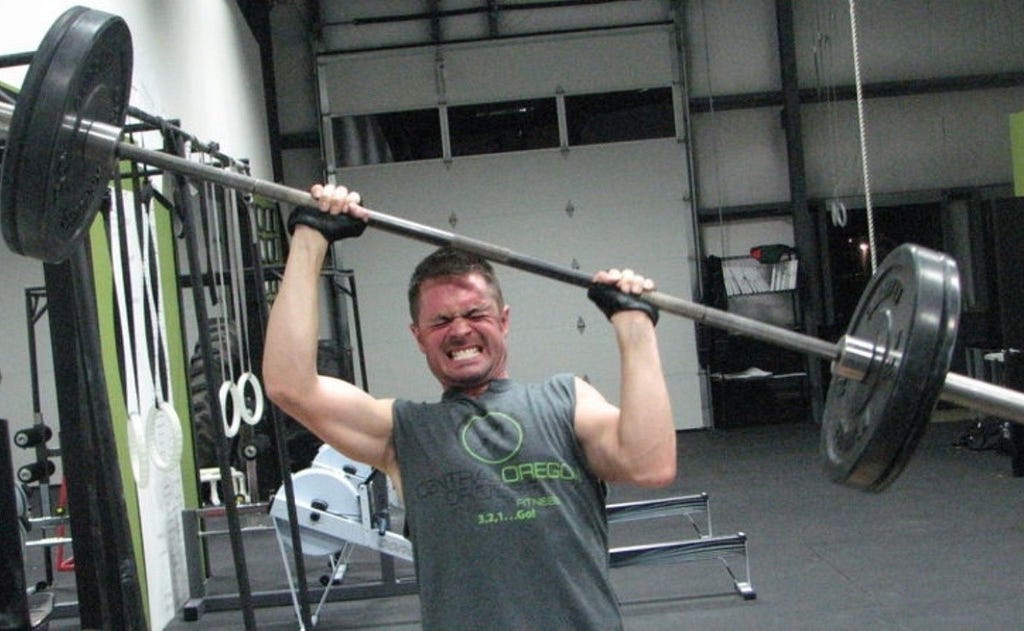 A picture of a guy who is definitely not loving it… and is barely working out.