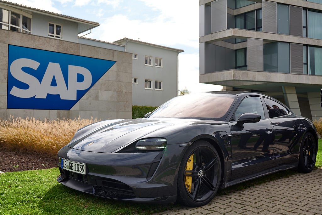 A Porsche in front of an SAP sign.