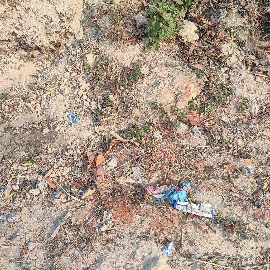 plastic wrappers , polythene , cigarette packages , gutka packages seen in the way to Talu dada