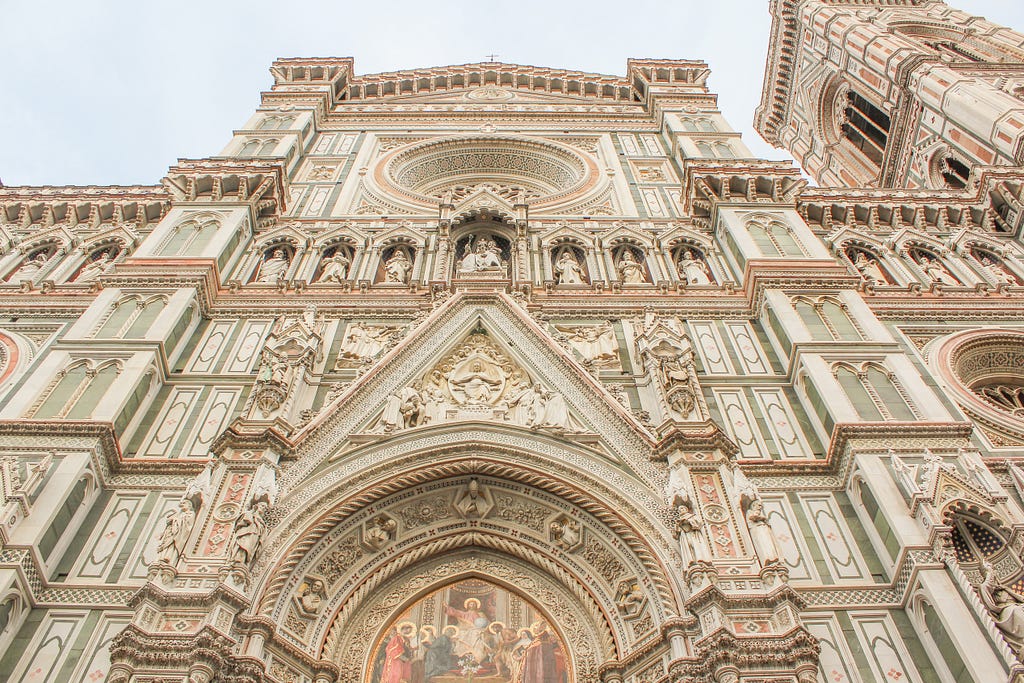 grand cathedral in florence with slabs of green, white and pink marble