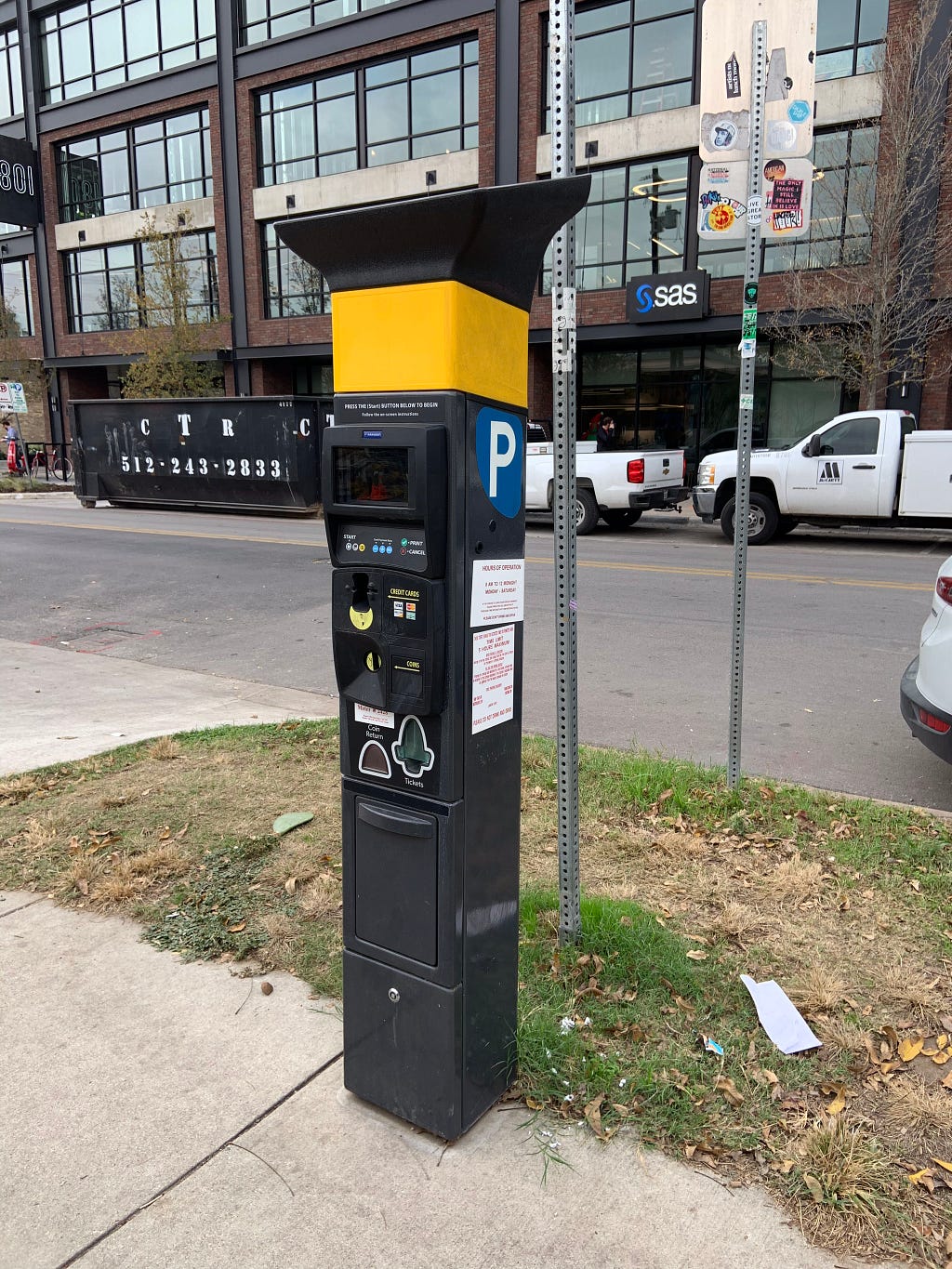 A typical parking meter in Austin Texas, that prints stickers to show payment. Drivers put the stickers inside their windows.