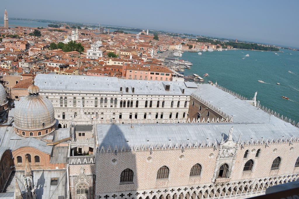 The Palazzo Ducale, a large building with white and pink brickwork.